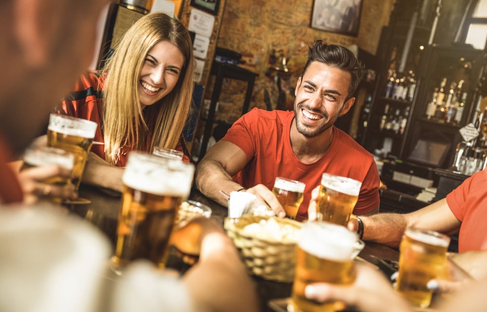 people eating and drinking beer in a pub