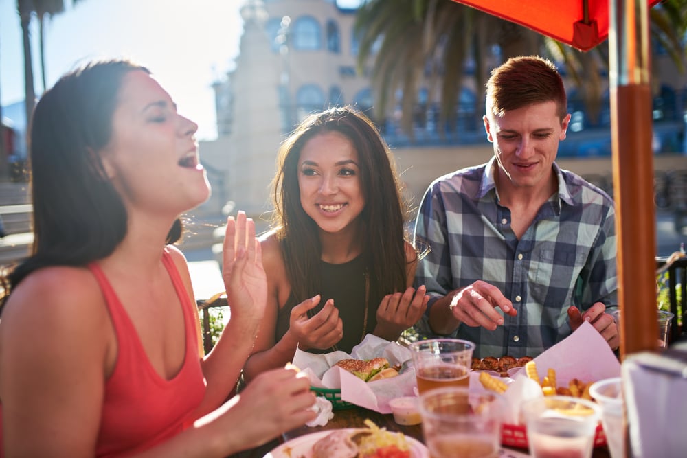 people eating outside of a restaurant in Miami beach florida