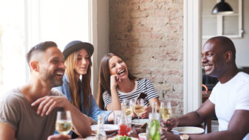 four friends enjoying their time dining at a restaurant in San Francisco