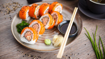 Sushi maki rolls with spicy crab, salmon, cucumber on a plate