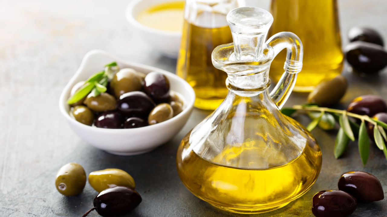 Olive oil in vintage bottles with black and green olives