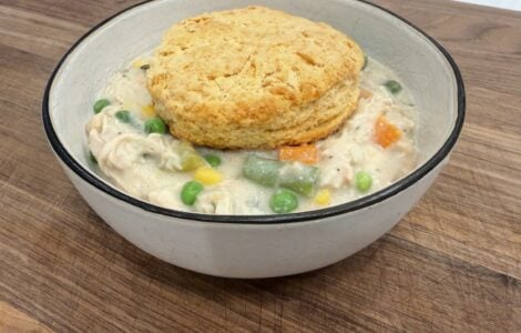 Bowl of crockpot chicken pot pie topped with a golden biscuit