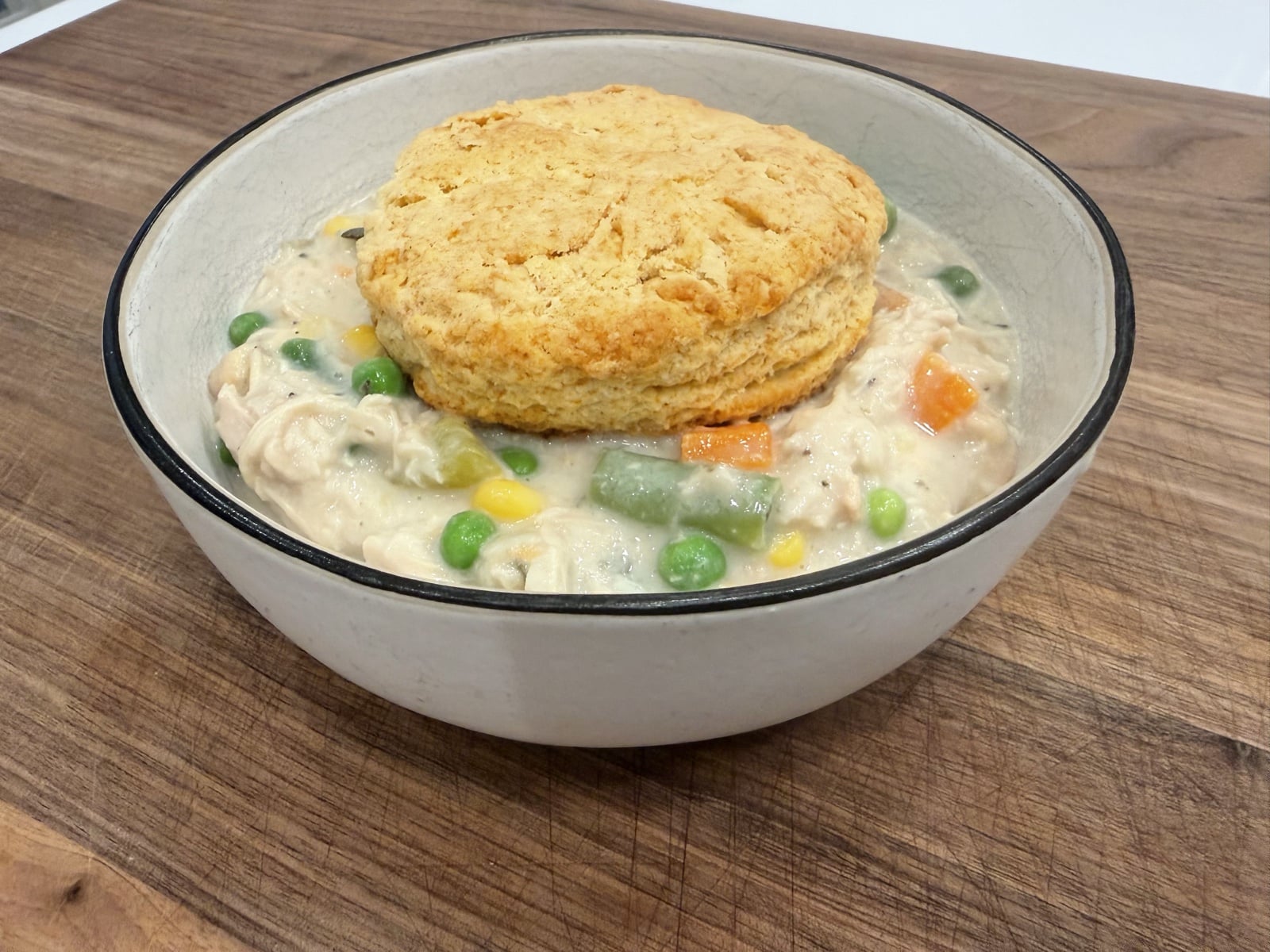 Bowl of crockpot chicken pot pie topped with a golden biscuit