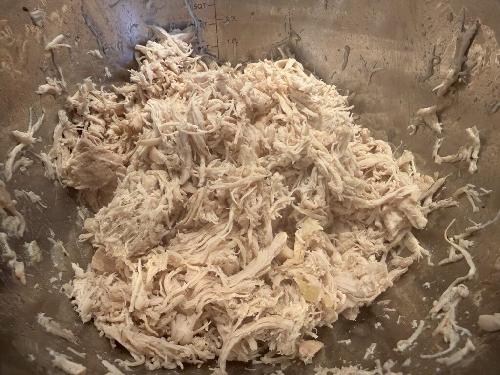 Cooked chicken shredded with two forks