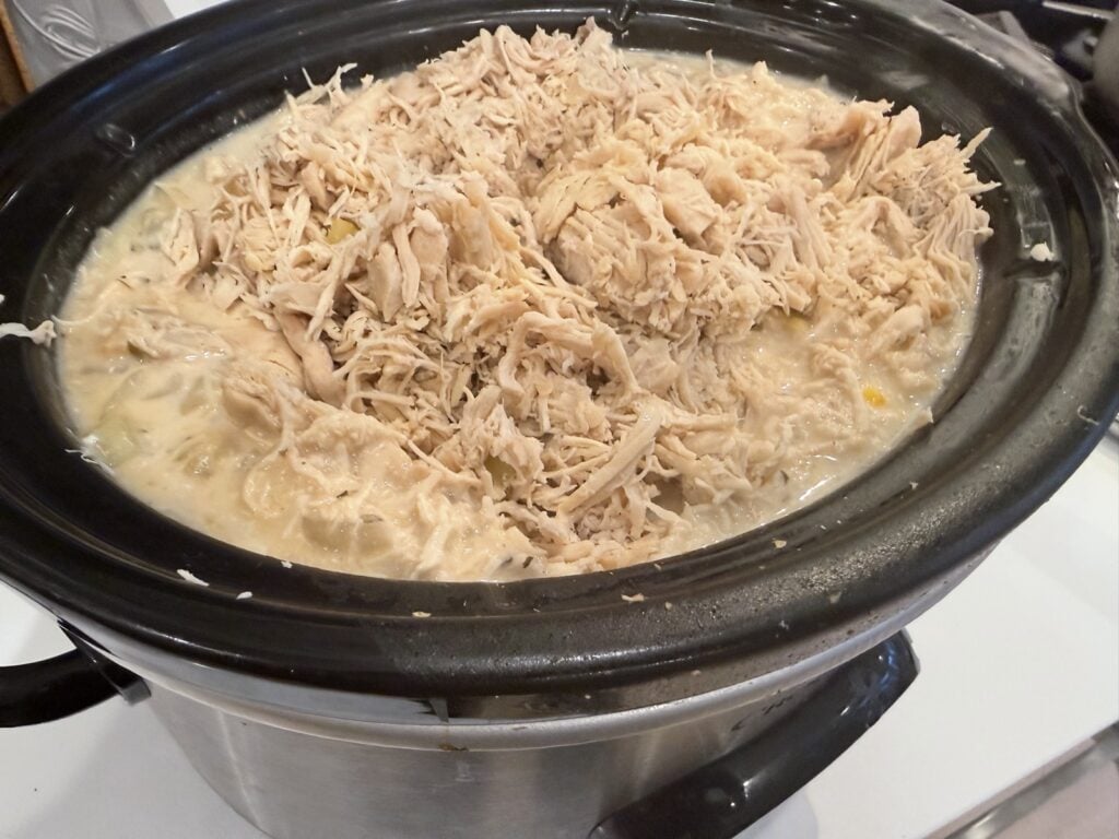Shredded chicken added back into the slow cooker